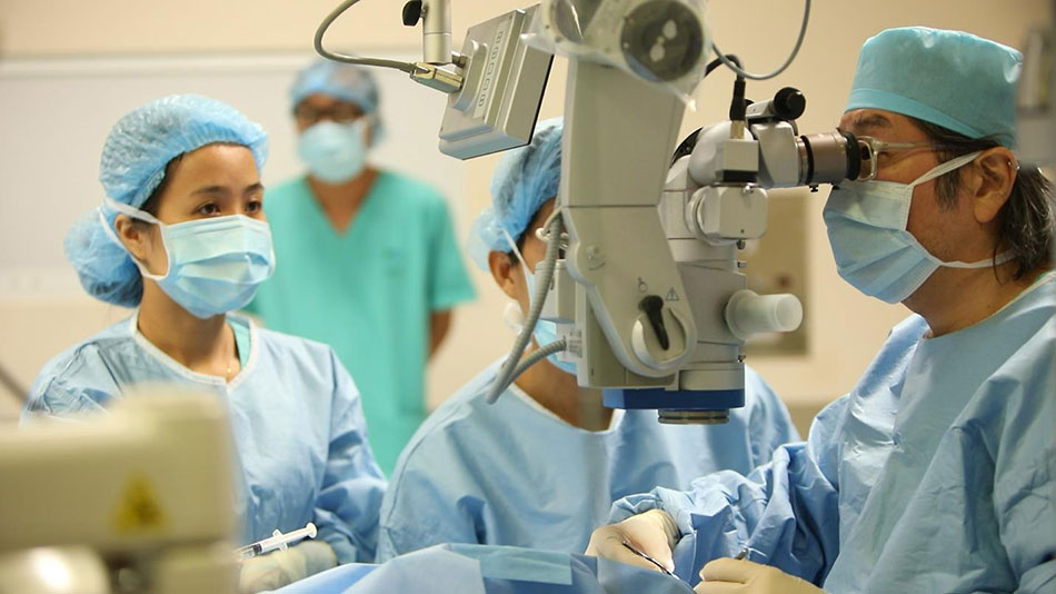 Ophthalmologist examining a patient before corneal transplant