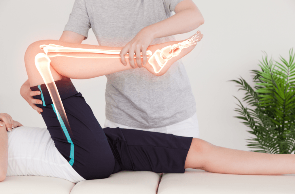 Physical therapist helping a patient with knee joint mobility and rehabilitation exercises after knee replacement surgery.