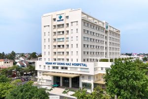 Hoan My Saigon Hospital main entrance in Ho Chi Minh City with modern building and Vietnamese signage.