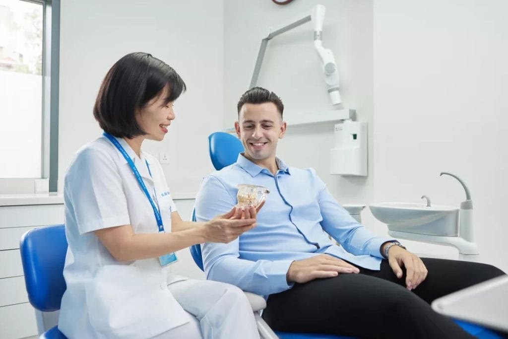 Dental work in Vietnam for Australians – dentist consulting an international patient